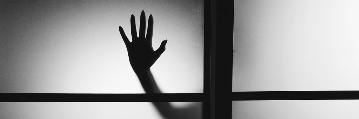 scary hand touching the door of a haunted house
