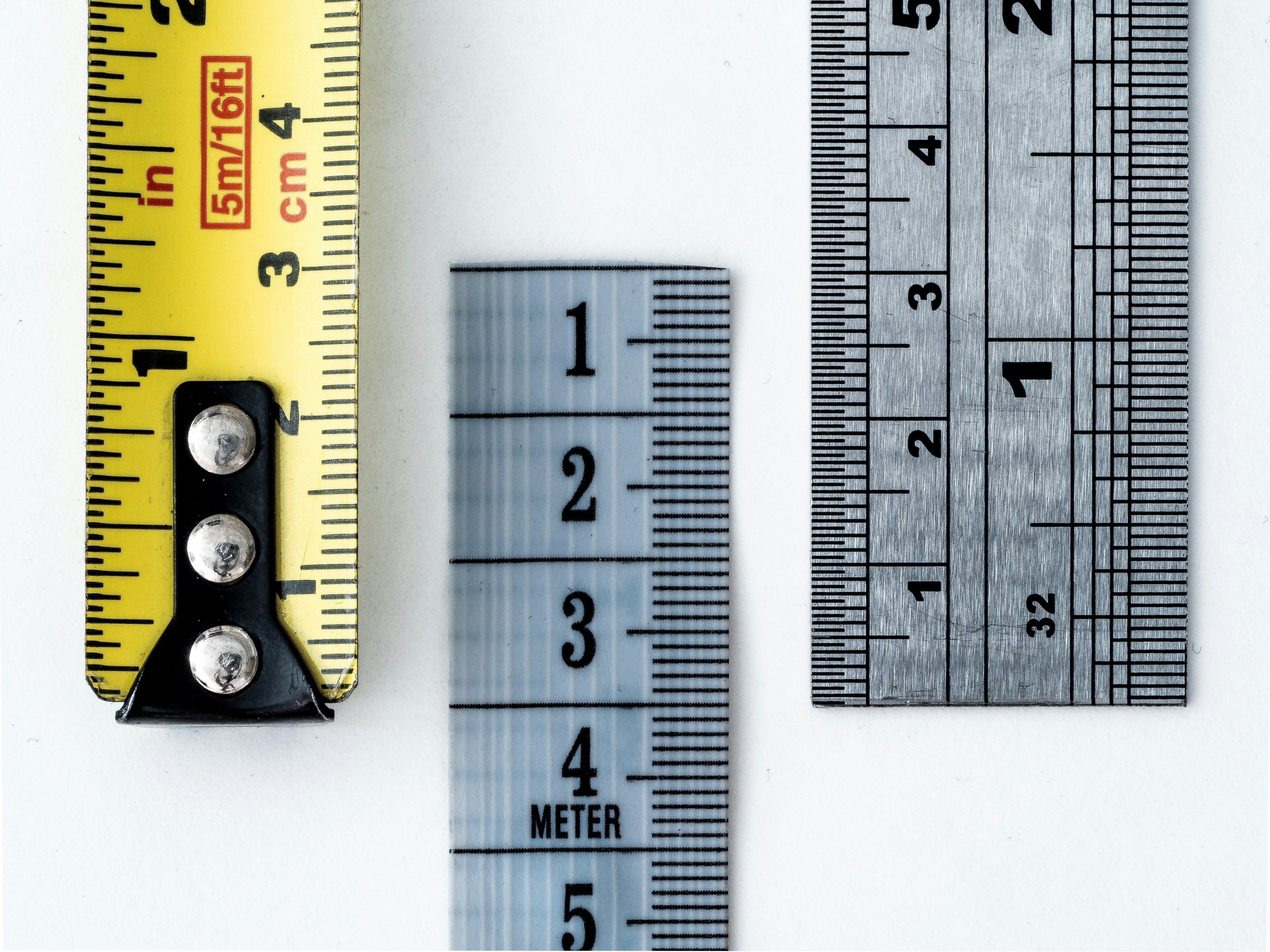 A measuring tape and two rulers. All can be used to confirm penis length.